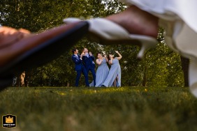 Bridal party portrait on the lawn at Foxie House in Sandwich, MA, styled with playful energy and creative composition, showcasing unique perspectives and joyful celebration.